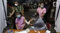 Vaksinator bersiap usai menyuntikan vaksin Covid-19 kepada warga lansia di halaman Kantor Kecamatan Penjaringan, Jakarta, Kamis (19/8/2021). Vaksinasi malam ini digelar untuk menjangkau warga yang tidak bisa vaksinasi siang hari karena bekerja atau alasan lainnya. (Liputan6.com/Helmi Fithriansyah)