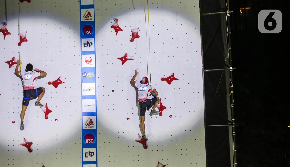 Atlet panjat tebing Indonesia Aspar Jailolo (kanan) beradu kecepatan dengan atlet panjat tebing Indonesia Kiromal Katibin saat final kategori speed dalam Kejuaran Dunia Panjat Tebing 2022 (International Federation of Sport Climbing/IFSC) di Jakarta, Sabtu (24/9/2022). Aspar berhasil mengalahkan lawan yang juga kompatriotnya, Kiromal Katibin. Catatan waktu Aspar adalah 5,39 detik. (Liputan6.com/Faizal Fanani)