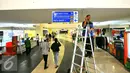 Pekerja memasang penunjuk arah di terminal terpadu Pulo Gebang, Jakarta, Selasa (27/12). Rencananya, terminal ini akan diresmikan pada 28 Desember nanti. (Liputan6.com/Angga Yuniar)