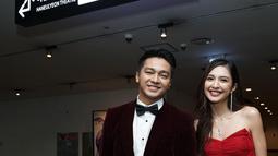 Penampilan pemain film Cinta Laki-Laki Biasa itu makin gagah saat bersanding dengan Mikha Tambayong. Sang kekasih sendiri mengenakan gaun panjang bernuansa merah cerah. (Liputan6.com/IG/@devamahenra).