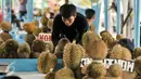 Pedagang merapihkan durian daganganya di Lokasi Sementara (Loksem) Pusat Penjualan Durian, Jalan TMP Kalibata, Jakarta Selatan, Kamis (9/2). Pemprov DKI Jakarta bangun Loksem Pusat Penjualan Durian di Kalibata. (Liputan6.com/Yoppy Renato)