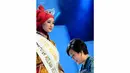 Ibu Harsiwi Achmad selaku Managing Director Indosiar mengenakan slendang kepada Annisa Darmawati (21) asal Jakarta yang dinobatkan sebagai Puteri Muslimah Indonesia 2014 (Liputan 6.com/Andrian M Tunay)
