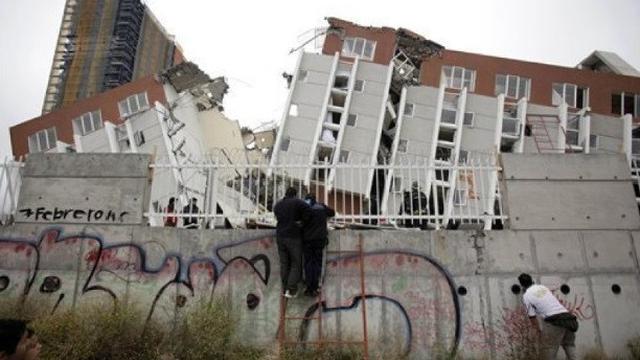 Orang-orang melihat bangunan yang runtuh di Concepcion, Chili, Minggu, 28 Februari 2010. Gempa berkekuatan 8,8 melanda Chili pada Sabtu pagi.