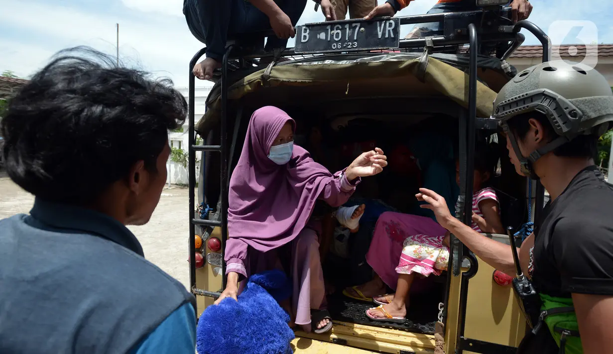 Tim Tanggap Bencana Land Rover Club Indonesia (LRCI) mengevakuasi warga korban banjir di Desa Sindangsari, Kabupaten Bekasi, Jawa Barat, Rabu (24/2/2021). Banjir yang melanda kawasan tersebut diakibatkan jebolnya tanggul Sungai Citarum dan luapan air Sungai Ciherang. (merdeka.com/Imam Buhori)