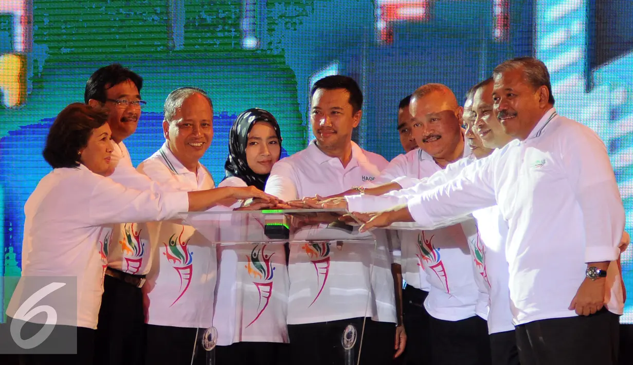 Menpora, Imam Nahrawi (tengah) bersama beberapa pihak terkait menekan tombol peluncuran logo Asian Games ke-18 pada perayaan Hari Olahraga Nasional ke-32 di Istora Senayan Jakarta, Rabu (9/9/2015). (Liputan6.com/Helmi Fithriansyah) 