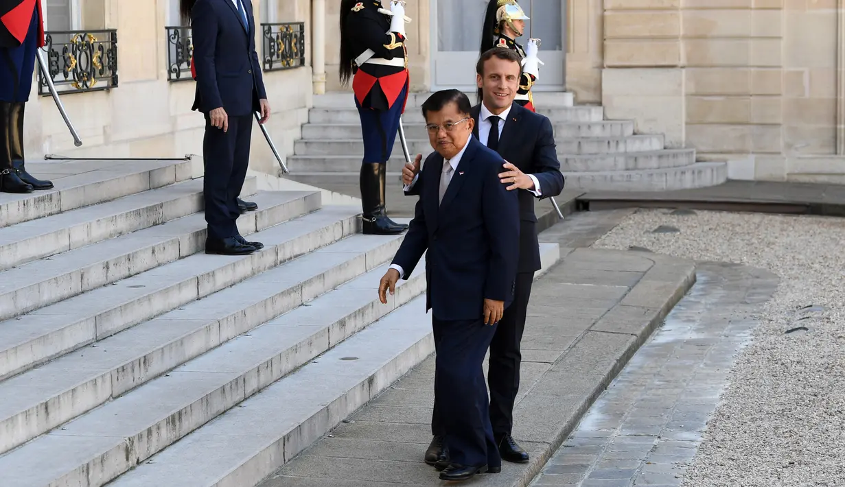 Presiden Prancis Emmanuel Macron (kanan) menyambut Wakil Presiden Indonesia Jusuf Kalla saat menghadiri KTT Paris: Ekstremisme Online di Istana Elysee, Paris, Prancis, Rabu (15/5/2019). Forum ini membahas pencegahan terorisme melalui penggunaan dunia digital. (REUTERS/Philippe Wojazer)