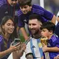 Bintang Argentina, Lionel Messi memilih merayakan kemenangan dengan bercengkrama dengan keluarga yang ikut datang ke stadion, yaitu sang istri Antonella Rocuzzo beserta anak mereka. (AP Photo/Manu Fernandez)