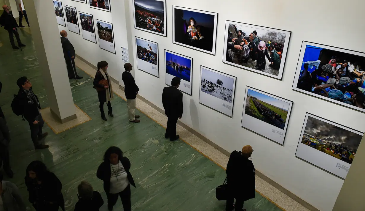 Sejumlah pengunjung mengambil foto saat pameran karya fotografer Agence France-Presse (AFP) mengenai krisis migrasi di Eropa di pusat seni Bozar di Brussels (3/5). Pameran ini berjudul "Puting a Face on the Invisibles. (AFP Photo/John Thys)