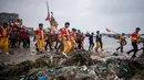 Penduduk desa menggunakan tandu membawa seorang pria berpakaian seperti Dewa Laut menuju pantai desa Fuye, Provinsi Fujian, Tiongkok (5/3). Ritual ini untuk meminta tangkapan ikan yang melimpah. (AFP Photo/Johannes Eisele)