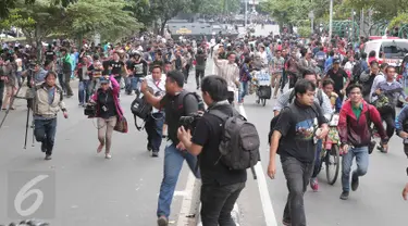 Para jurnalis lari berhamburan seusai mendengar isu bom yang akan kembali meledak pasca terjadinya ledakan yang terjadi di Pos polisi dekat pusat perbelanjaan Sarinah, Jalan Thamrin, Jakarta, Kamis (14/1). (Liputan6.com/Angga Yuniar)