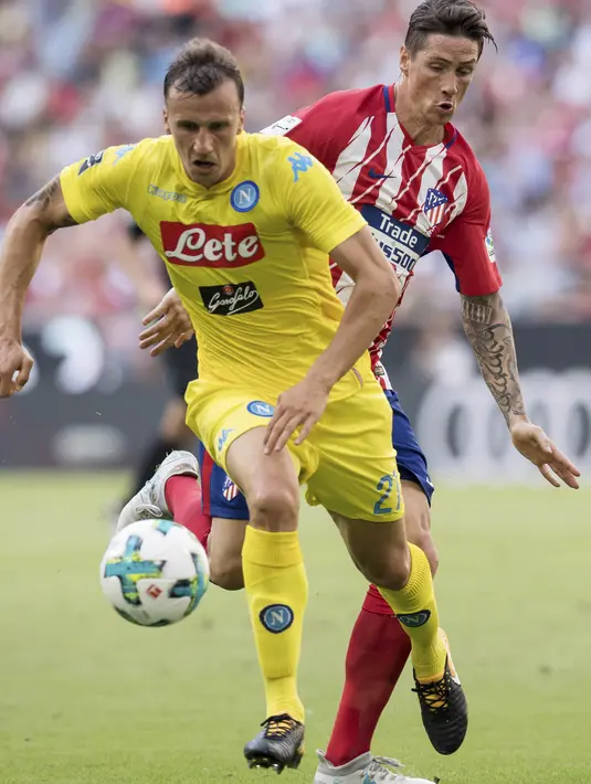 Striker Atletico Madrid, Fernando Torres, berebut bola dengan bek Napoli, Vlad Chiriches, pada laga turnamen pramusim Audi Cup 2017 di Stadion Allianz, Munchen, Selasa (1/8/2017). Atletico Madrid menang 2-1 atas Napoli. (AP/Sven Hoppe)