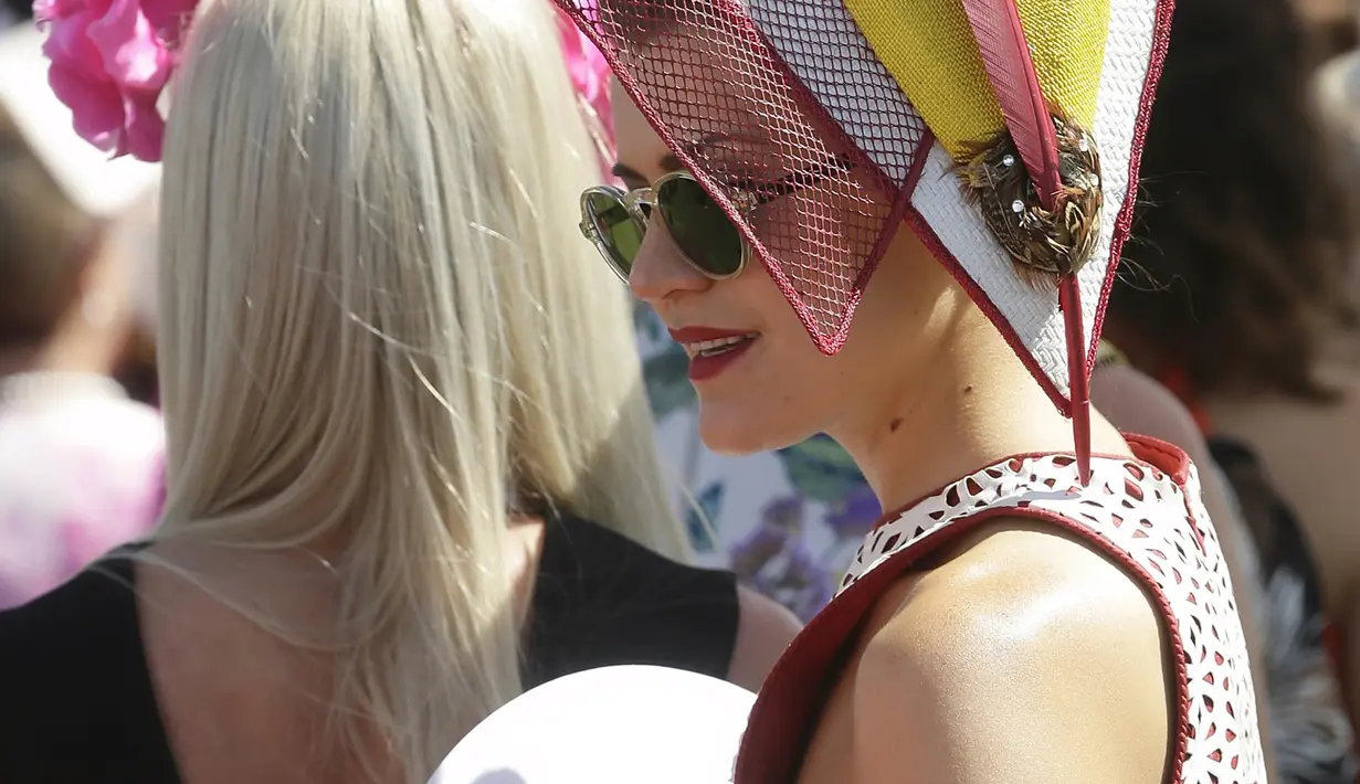 Seorang wanita berdandan "Housewife Style Era" tahun 50-an saat menghadiri perlombaan pacuan kuda Melbourne Cup di Flemington Racecourse di Melbourne ,Australia, (3/11/2015). Lomba pacuan kuda ini menjadi yang termahal di Australia. (REUTERS/Hamish Blair)