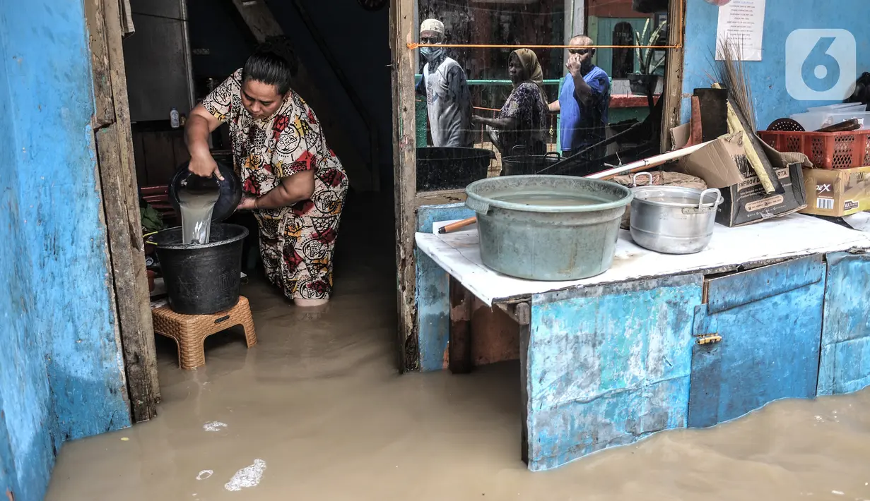 Aktivitas warga saat banjir merendam permukiman di Kebon Pala, Jakarta, Senin (8/2/2021). Hujan deras yang mengguyur Ibu Kota dan wilayah Bogor menyebabkan permukiman di Kebon Pala terendam banjir sejak Minggu (7/2/2021) sore. (merdeka.com/Iqbal S. Nugroho)