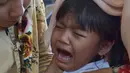 Seorang anak menangis saat disuntik vaksin difteri di sebuah klinik desa di Jakarta (11/12). Wabah Difteri ini telah menewaskan puluhan orang. (AFP Photo/Adek Berry)