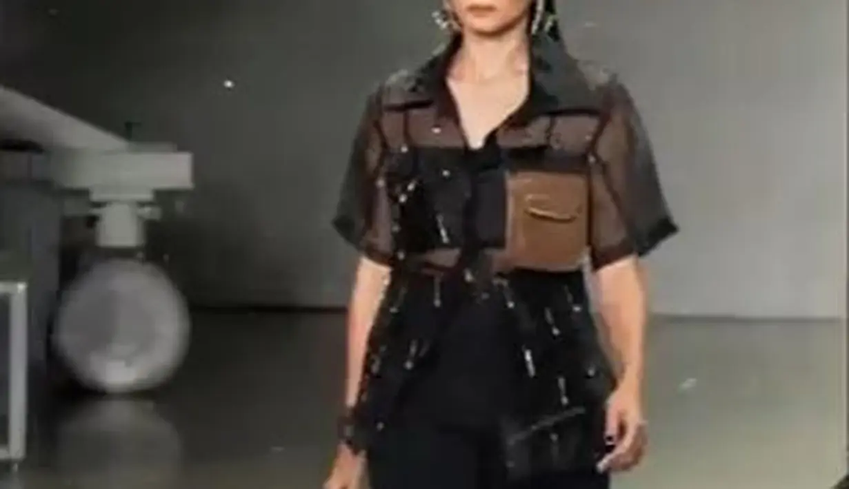 Enzy Storia, tampil bak seorang peragawati profesional dengan atasan lengan pendek yang digabungkan dengan celana hitam serta kacamata hitam.. (Foto: Instagram/@erigostore)