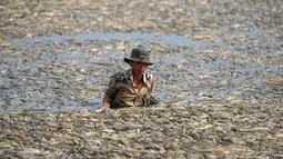 Air waduk seluas 300 hectare tersebut hampir tidak terlihat, tertutup ikan-ikan yang mati. (STR / AFP)