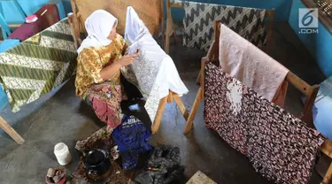 Seorang ibu membuat batik tulis di Kampung Batik Puswasedar kawasan Geopark Ciletuh, Sukabumi, Jawa Barat, Sabtu (22/9). Lebih dari 50 perempuan menekuni pembuatan batik tulis maupun cetak. (Merdeka.com/Arie Basuki)