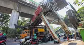 Sebuah truk truk towing pengangkut alat berat (crane) tersangkut dan merusak jembatan penyeberangan orang (JPO) di Jalan Raya Kapten Tendean, Jakarta, Selasa (14/07/2026).