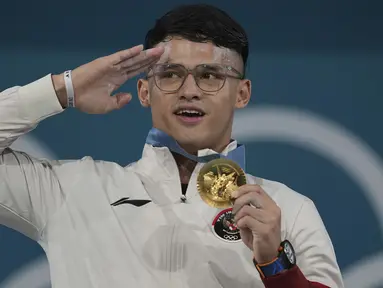 Tampil di urutan terakhir dari total 29 atlet Indonesia yang berlaga di Olimpiade Paris 2024, Rizki Juniansyah betul-betul menjadi penutup yang manis bagi kontingen Indonesia. Atlet berusia 21 tahun itu sukses menyumbang medali emas kedua untuk Indonesia dai kelas 73 kg putra cabor angkat besi yang berlangsung di Paris Expo Porte de Versailles, Paris, Jumat (9/8/2024) dini hari WIB. Rizki mampu mengangkat total 354 kg yang menjadi rekor baru Olimpiade dengan rincian 155 kg pada angkatan snatch dan 199 kg untuk clean and jerk. (AP Photo/Kin Cheung)