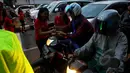Sejumlah pengendara roda dua mendapatkan bingkisan coklat fullo sebagai apresiasi disiplin berlalu lintas di kawasan perempatan Cideng, Jakarta, Senin (23/2). (Liputan6.com/Johan Tallo)