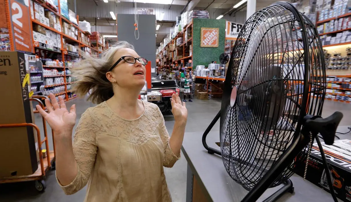 Davi Sobotta bereaksi saat mencoba kipas meja menjelang gelombang panas di toko perlengkapan Home Depot di Seattle, Selasa (1/8). Peringatan cuaca panas yang berlebihan untuk wilayah itu dimulai pada Selasa sore dan hingga Jumat malam (AP/Elaine Thompson)