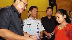 Bupati Aceh Tenggara Hasanuddin (kiri) menyerahkan santunan kepada Silviana Aisyah, ahli waris korban kecelakaan pesawat NBA Cassa 212, di Kutacane,Aceh Tenggara, Rabu (5/10). (Antarafoto)