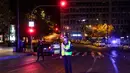 Petugas kepolisian menunggu untuk memeriksa dokumen pengemudi di Athena, Yunani, Minggu (25/10/2020). Pemerintah Yunani telah memberlakukan jam malam di Athena, Thessaloniki, dan daerah lain dengan tingkat infeksi COVID-19 yang tinggi serta kewajiban penggunaan masker. (AP Photo/Yorgos Karahalis)