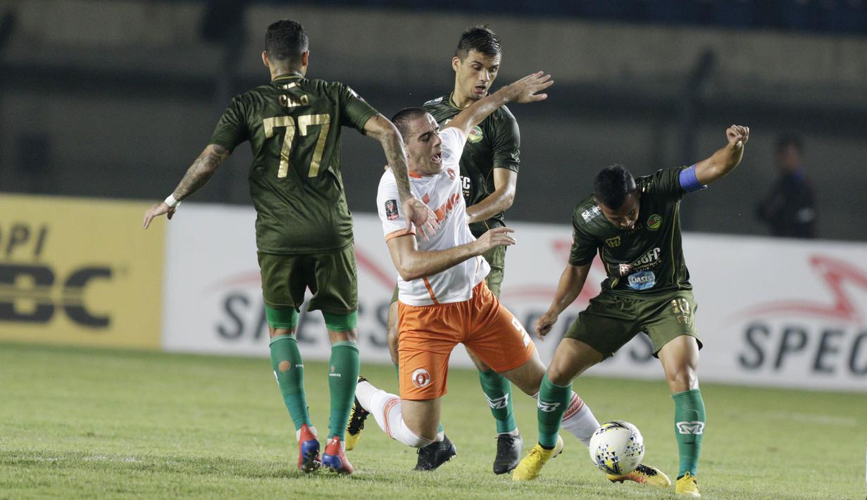 Striker Perseru Serui, Turkovic Nedo, terjatuh saat berebut bola dengan pemain Tira Kabo pada laga Piala Presiden 2019 di Stadion Si Jalak Harupat, Jawa Barat, Kamis (7/3). (Bola.com/M Iqbal Ichsan)