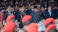 Presiden Prabowo Subianto memimpin sekaligus menjadi inspektur upacara Hari Ulang Tahun (HUT) ke-79 Bhayangkara yang diselenggarakan di Lapangan Monumen Nasional (Monas), Jakarta Pusat, pada Selasa 1 Juli 2025. (BAY ISMOYO/AFP)