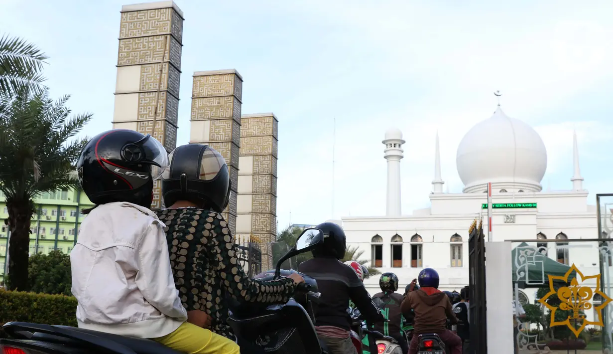 Pengendara motor antre mengambil takjil yang dibagikan dengan sistem drive thru di Masjid Agung Al-Azhar, Jakarta, Selasa (5/5/2020). Selama Ramadan, pengurus Masjid Agung Al-Azhar membagikan 300 takjil per hari buat pengendara yang melintasi lokasi tersebut. (Liputan6.com/Helmi Fithriansyah)
