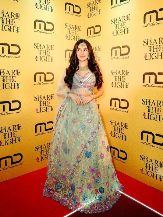 Beby Tsabina tampil menawan dengan kain sari motif bunga berwarna hijau mint dengan motif bunga dan rambut curly yang dibiarkan terurai.