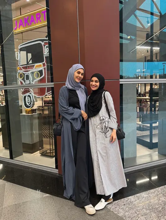 Kebersamaan Paula Verhoeven dan Shireen Sungkar. Paula tampil jenjang dengan atasan dan bawahan hitam, ditumpuknya mengenakan outer Panjang abu-abu yang serasi dengan hijab polosnya, dan sneakers putih. [Foto: Instagram/paula_verhoeven]