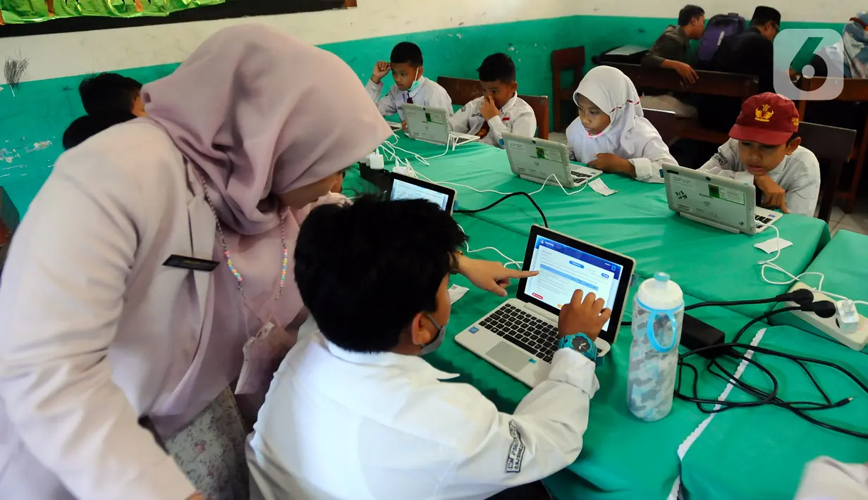 Siswa SDN Pondok Petir 01 mendapat pendampingan saat mengikuti Asesmen Nasional Berbasis Komputer (ANBK) di Depok, Jawa Barat, Selasa (4/10/2022). Diharapkan siswa dapat melaksanakan tugasnya terkait ANBK sehingga pada pelaksanaannya tidak terjadi kendala (merdeka.com/Arie Basuki)