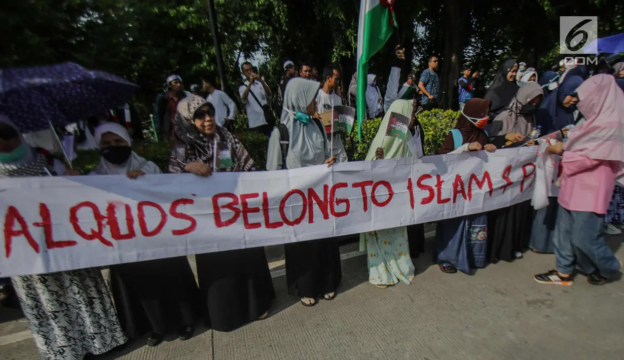 Massa membentangkan spanduk saat menggelar aksi terkait keuputusan Presiden AS, Donald Trump yang mengkali Yerusalem sebagi ibu kota Israel di depan kantor Kedutaan Besar AS, Jakarta, Jumat (8/11). (Liputan6.com/Faizal Fanani)
