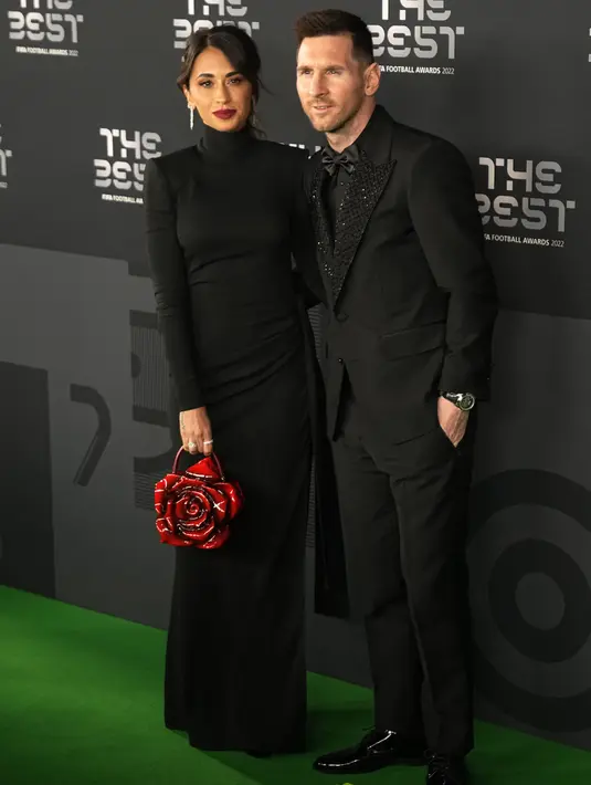 Megabintang Timnas Argentina dan PSG, Lionel Messi berpose bersama istrinya Antonela Roccuzzo di karpet hijau sebelum Seremoni The Best FIFA Footbal Awards 2022 di Paris, Prancis, Senin (27/2/2023). (AP Photo/Michel Euler)
