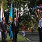 Presiden Joko Widodo berjalan bersama Perdana Menteri Selandia Baru John Key disambut pelajar yang mengibarkan bendera saat upacara penyambutan di Halaman Istana Merdeka, Jakarta, Senin (18/7). (Liputan6.com/Faizal Fanani)