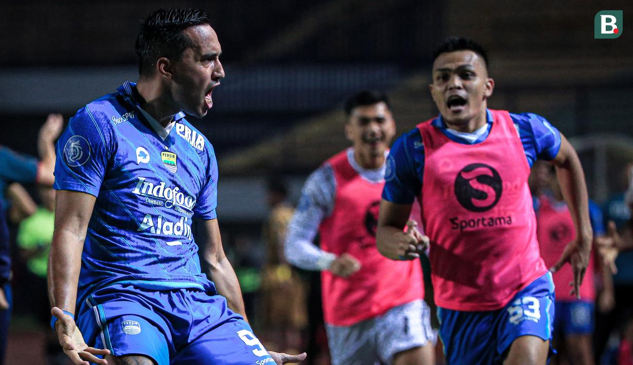 Selebrasi pemain Persib Bandung, Ezra Walian (kiri), setelah mencetak gol penyeimbang kedudukan ke gawang Dewa United pada menit ke-90+2 dalam pertandingan lanjutan pekan ketiga BRI Liga 1 2023/2024 yang berlangsung di Stadion Gelora Bandung Lautan Api, Jawa Barat, Jumat (14/7/2023). (Bola.com/Bagaskara Lazuardi)