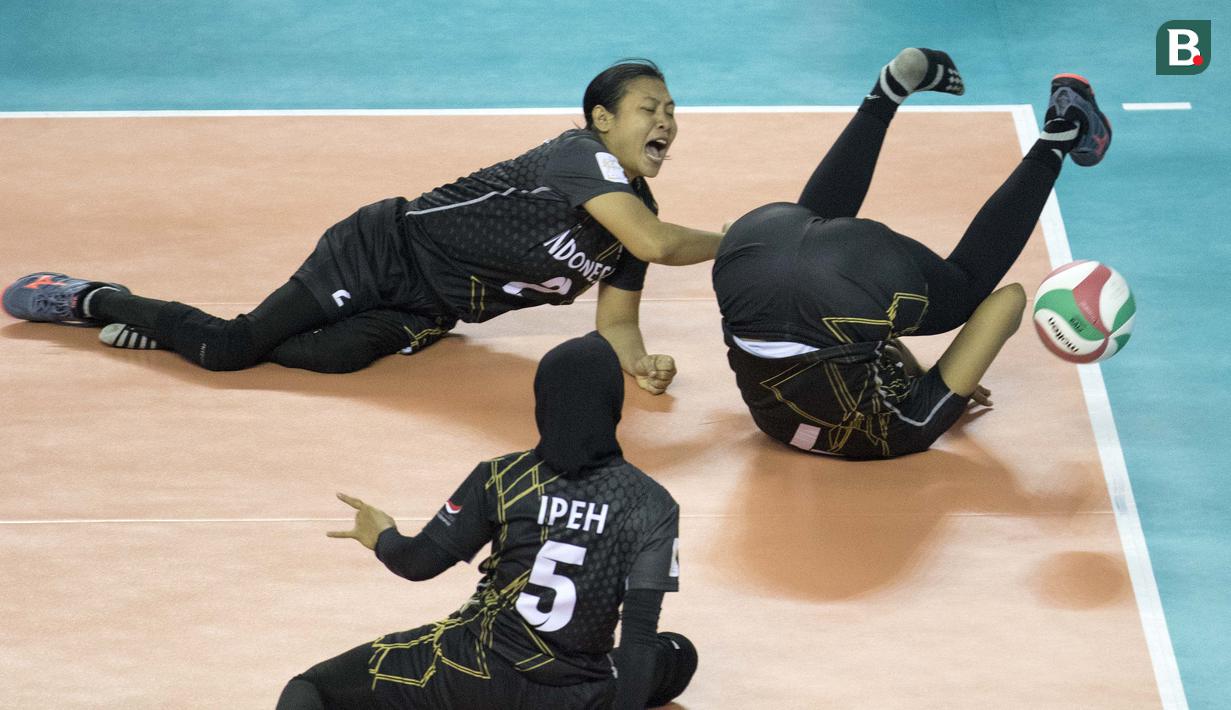 Aksi Lestary Anissa (terbalik) atlet voli Indonesia di semifinal bola voli duduk melawan China pada  Asian Para Games 2018, di Tennis Indoor Gelora Bung Karno Jakarta, Rabu (10/10/2018).  (Bola.com/Peksi Cahyo)