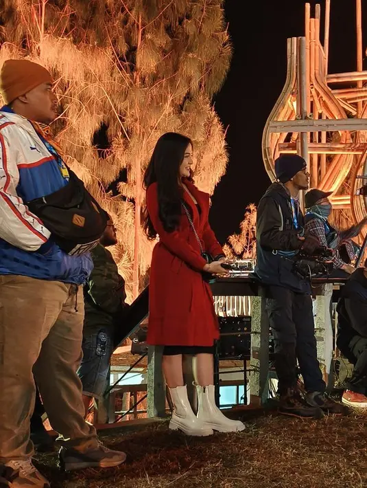 Bella tampil cantik dengan coat panjang warna merah dan memadukan dengan sepatu boots tinggi warna putih. Istri Denny Caknan tampak anggun disamping panggung. [dok.Kapanlagi/istimewa]