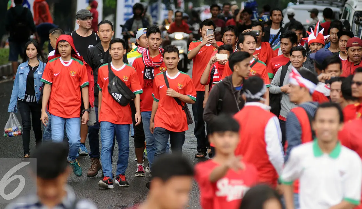  Pendukung Timnas Indonesia berjalan menuju Stadion Pakansari, Bogor (3/12). Timnas Indonesia akan melakoni laga semifinal pertama Piala AFF 2016 melawan Vietnam di Stadion Pakansari Kab Bogor. (Liputan6.com/Helmi Fithriansyah)