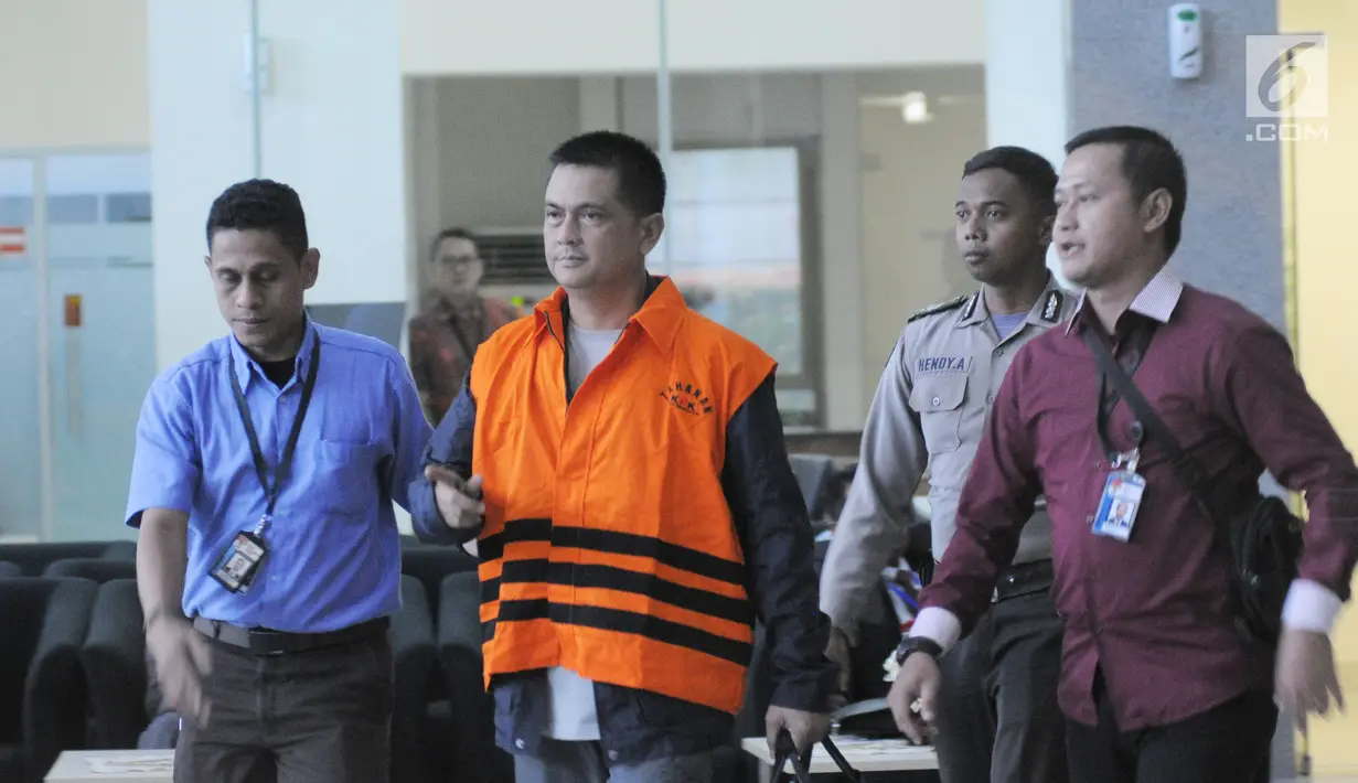 Hasmun Hamzah dikawal petugas berjalan meninggalkan gedung KPK usai menjalani pemeriksaan, Jakarta, Kamis (1/3). Adriatma diduga menerima uang suap sebesar Rp 2,8 miliar dari Direktur PT Sarana Bangun Nusantara Hasmun Hamzah.(Liputan6.com/Herman Zakharia)