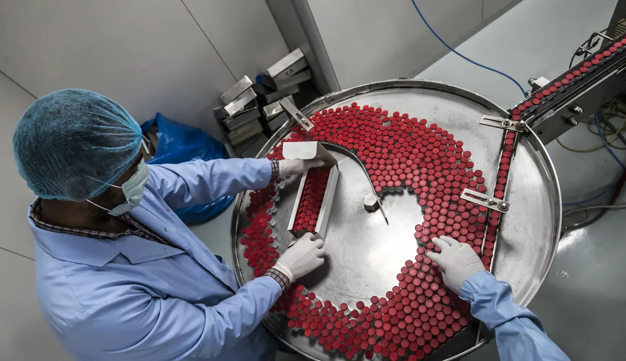 Pekerja laboratorium saat mengawasi produksi botol vaksin Sinovac di laboratorium Vacsera, Kairo, Mesir, Rabu (1/9/2021). Laboratorium Vacsera di Mesir membuat vaksin Sinovac China untuk mencegah penularan virus corona. (AFP/Khaled Desouki)