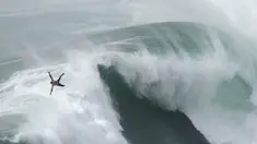 Peselancar Eric Rebiere dari Prancis mengudara keluar dari ombak selama kompetisi selancar ombak besar Nazare Tow Challenge di Praia do Norte, atau Pantai Utara, di Nazare, Portugal, 10 Februari 2022. (AP Photo/Armando Franca)