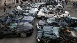 Puluhan mobil mewah usai dilindas buldoser saat peringatan ulang tahun Biro Bea Cukai Filipina ke-116 di Metro Manila, Filipina, (6/2). Mobil-mobil tersebut merupakan hasil dari kasus penyelundupan. (AP Photo/Bullit Marquez)