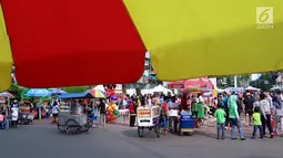 Pedagang kaki lima (PKL) tumpah ruah saat Car Free Day di kawasan Senayan, Jakarta, Minggu (8/10). Sebagian dari mereka menjajakan dagangannya di pendestrian hingga ke tengah jalan. (Liputan6.com/Fery Pradolo)