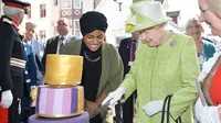 Wajah bahagia Ratu Inggris Elizabeth II saat memotong kue yang ditemani oleh Nadiya Husein pada perayaan hari ulang tahunnya ke-90 di Istana Windors, Berkshire, Inggris (21/4/2016). (AFP PHOTO/John Stillwell)