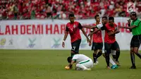 Wasit Nagor Amir Amir Bin Noor Mohamed melihat Evan Dimas terjatuh oleh dorongan pemain Timor pada laga penyisihan grup B SEA Games 2017 di Stadion Majlis Perbandaran Selayang, Malaysia, Minggu (20/8). (Liputan6.com/Faizal Fanani)