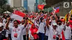 Peserta parade membawa bendera anggota ASEAN saat berjalan dalam Parade Asean di Jalan MH. Thamrin, Jakarta, Minggu (29/1/2023). Acara tersebut merupakan 'kick off' keketuaan Indonesia dalam ASEAN 2023 yang puncaknya akan berlangsung dua kali, yakni Konferensi Tingkat Tinggi (KTT) ASEAN pada Mei 2023 di Labuan Bajo, Provinsi Nusa Tenggara Timur (NTT) dan KTT ASEAN Plus di Jakarta pada September 2023. (Liputan6.com/Angga Yuniar)