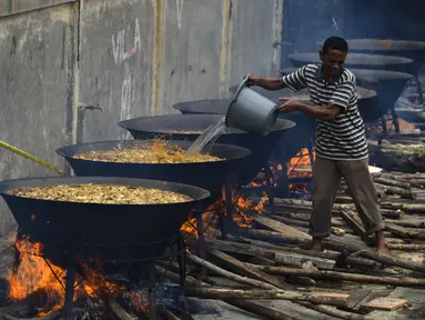 Seorang pria memasak kari tradisional untuk disajikan dalam makanan komunal selama bulan suci Ramadhan di Banda Aceh (25/4/2021). Menu ini sering dimasak setiap memperingati kenduri Nuzul Quran pada setiap pertengahan bulan suci Ramadhan. (AFP/Chaideer Mahyuddin)