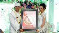 Hengky Kurniawan dan Sonya Fatmala memperlihatkan mahar pernikahan mereka seusai prosesi akad nikah di sebuah hotel kawasan TMII, Jakarta, Kamis (23/4/2015). (Liputan6.com/Panji Diksana)